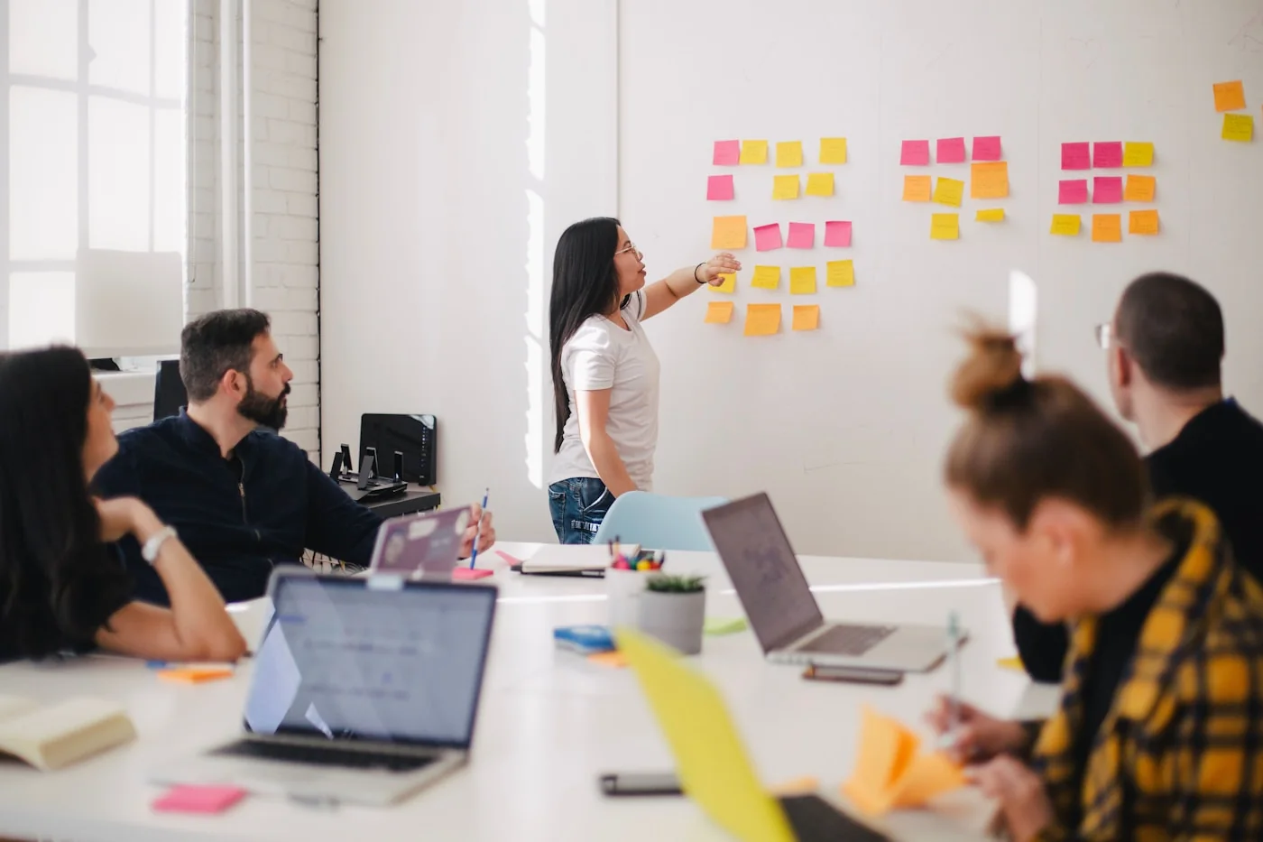 A communications team planning at a wall of notes
