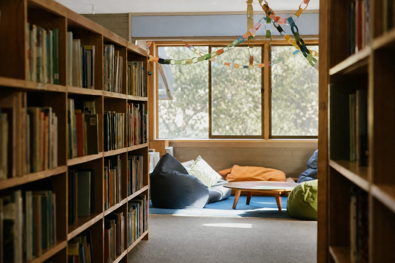 School library shelves leading to a reading corner with bean bags