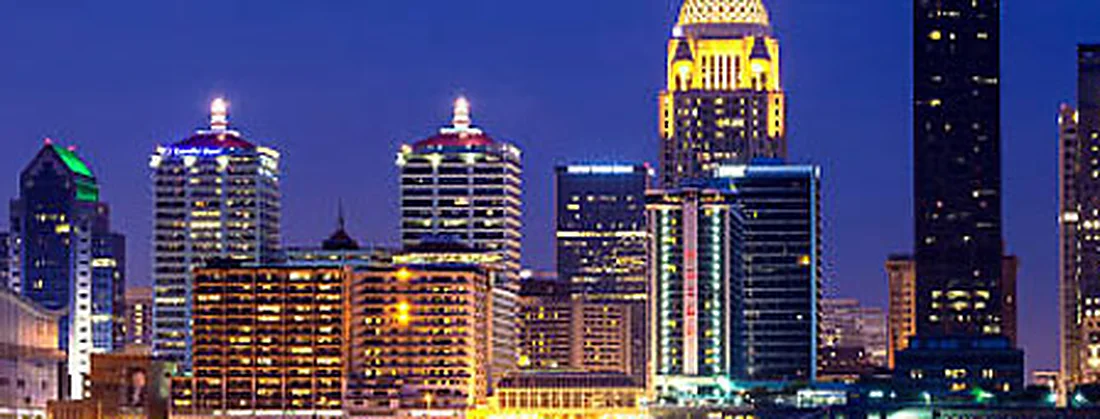 The Louisville skyline lit at night across the Ohio River