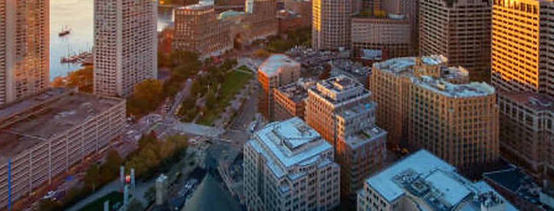 The Boston Financial District at sunrise, looking out to the harbor