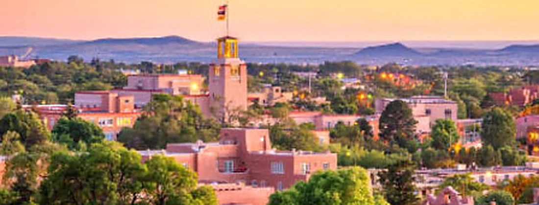 The low adobe rooftops of Santa Fe below the surrounding ridges